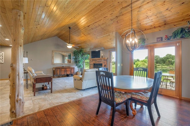 210 SE 200th Rd, Clinton, MO 64735 - dining area with a ceiling fan, wooden ceiling, vaulted ceiling, a fireplace, and light wood-type flooring