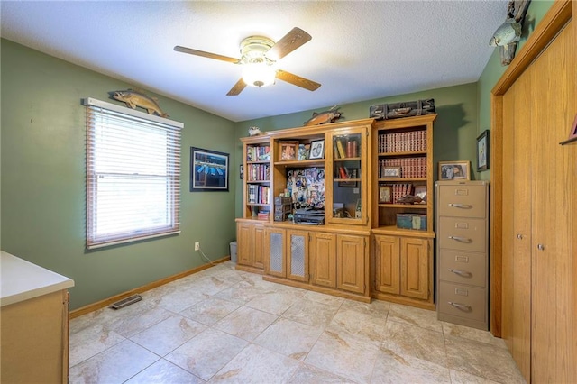 210 SE 200th Rd, Clinton, MO 64735 - office with ceiling fan and a textured ceiling