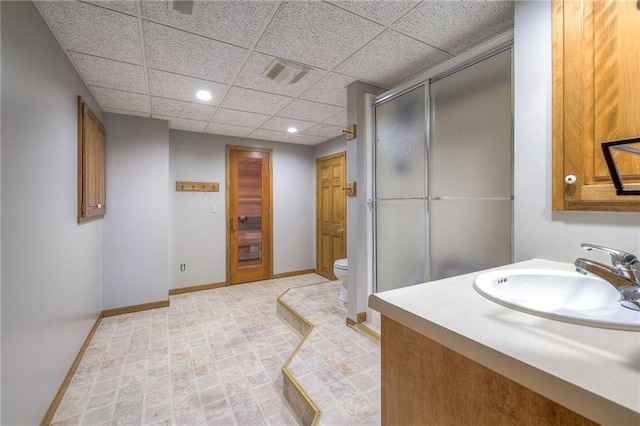 210 SE 200th Rd, Clinton, MO 64735 - full bath with toilet, a stall shower, a drop ceiling, baseboards, and recessed lighting