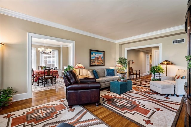 4618 Warwick Blvd Unit 6C, Kansas City, MO 64112 - living room with wood finished floors, ornamental molding, a chandelier, and baseboards
