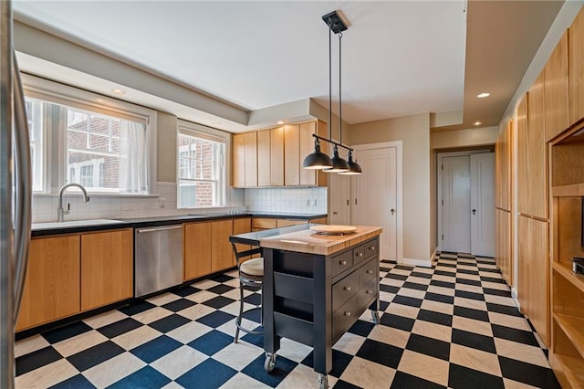 4618 Warwick Blvd Unit 6C, Kansas City, MO 64112 - kitchen with appliances with stainless steel finishes, light floors, tasteful backsplash, light brown cabinets, and a sink