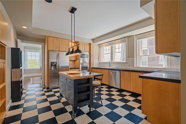 4618 Warwick Blvd Unit 6C, Kansas City, MO 64112 - kitchen featuring appliances with stainless steel finishes, plenty of natural light, tasteful backsplash, light floors, and recessed lighting