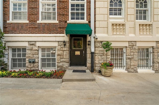 4618 Warwick Blvd Unit 6C, Kansas City, MO 64112 - doorway to property with stone siding and brick siding