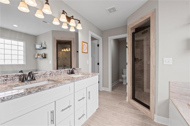 20711 W 49th St, Shawnee, KS 66218 - bathroom featuring double vanity, a stall shower, baseboards, toilet, and a tub to relax in