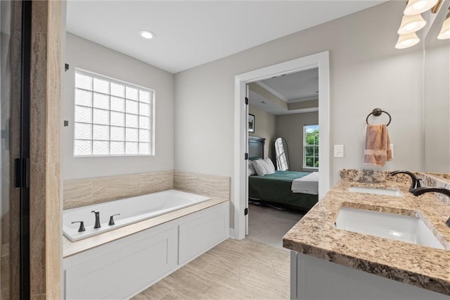 20711 W 49th St, Shawnee, KS 66218 - bathroom featuring double vanity, ensuite bathroom, a bath, and recessed lighting