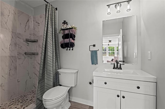 20711 W 49th St, Shawnee, KS 66218 - bathroom with toilet, a tile shower, vanity, and a ceiling fan