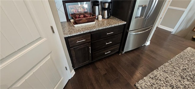 12432 Live Oak Cir, Peculiar, MO 64078 - kitchen featuring freestanding refrigerator, dark wood-type flooring, and light stone countertops