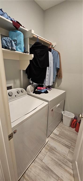 12432 Live Oak Cir, Peculiar, MO 64078 - laundry area with independent washer and dryer and light wood-style floors