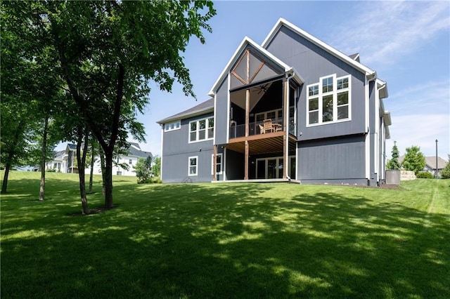 9291 Brownridge St, Lenexa, KS 66220 - back of property with a ceiling fan and a lawn