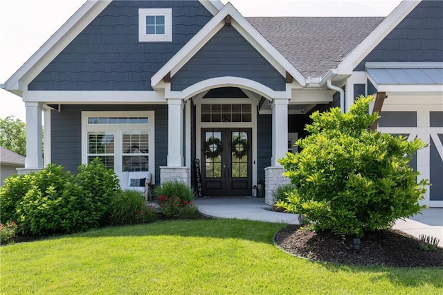 9291 Brownridge St, Lenexa, KS 66220 - property entrance featuring french doors, a lawn, and roof with shingles
