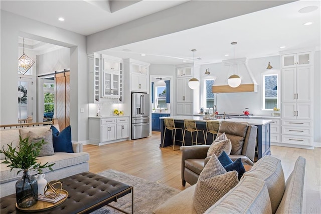 9291 Brownridge St, Lenexa, KS 66220 - living room with a barn door, light wood finished floors, and recessed lighting