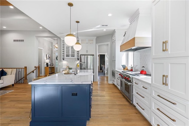 9291 Brownridge St, Lenexa, KS 66220 - kitchen with stainless steel appliances, premium range hood, recessed lighting, decorative backsplash, and white cabinets
