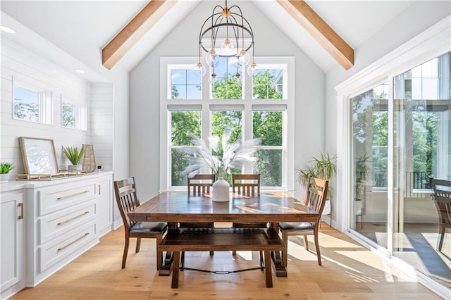 9291 Brownridge St, Lenexa, KS 66220 - dining space featuring light wood-style flooring, high vaulted ceiling, beam ceiling, and a chandelier