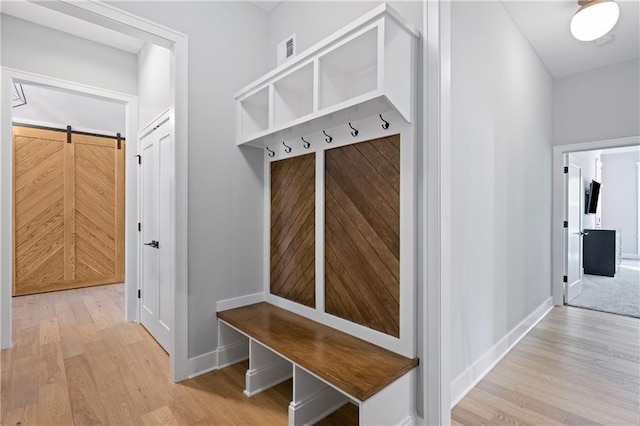 9291 Brownridge St, Lenexa, KS 66220 - mudroom featuring light wood-style flooring and a barn door