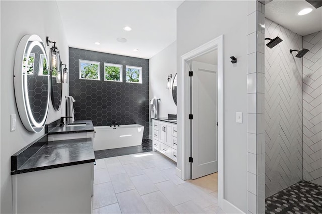 9291 Brownridge St, Lenexa, KS 66220 - bathroom featuring vanity, a soaking tub, walk in shower, recessed lighting, and tile patterned floors