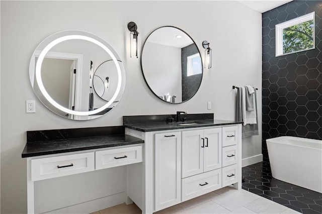 9291 Brownridge St, Lenexa, KS 66220 - bathroom with a freestanding bath, vanity, and tile patterned flooring