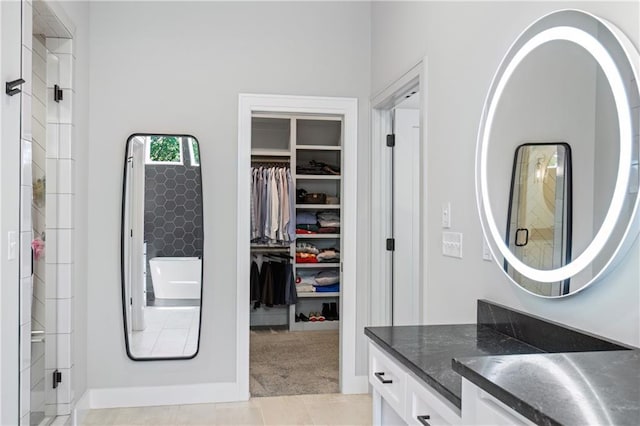 9291 Brownridge St, Lenexa, KS 66220 - bathroom featuring vanity, a walk in closet, and a shower