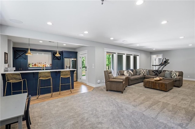 9291 Brownridge St, Lenexa, KS 66220 - living area with light carpet, recessed lighting, wet bar, and light wood finished floors