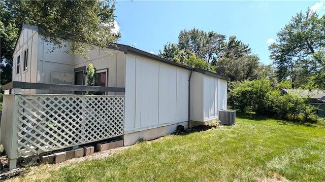 8476 Lane Dr, Raytown, MO 64138 - view of side of home with a lawn and a cooling unit