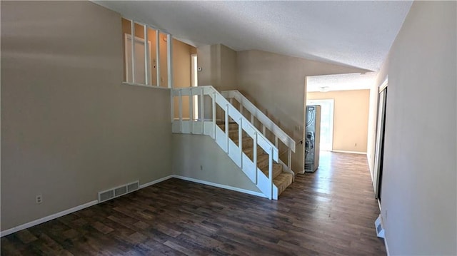 8476 Lane Dr, Raytown, MO 64138 - stairs with vaulted ceiling, wood finished floors, and a textured ceiling