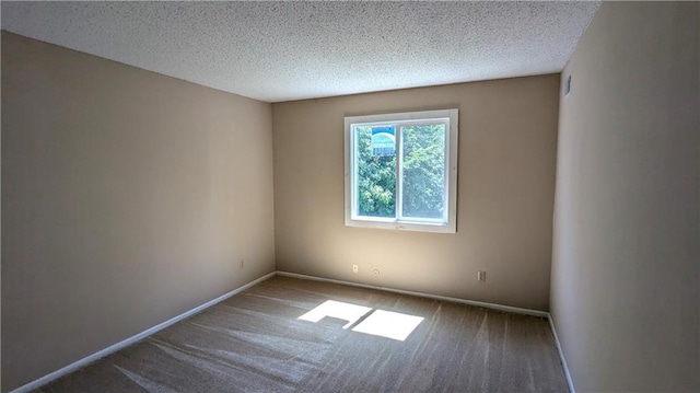 8476 Lane Dr, Raytown, MO 64138 - carpeted spare room featuring baseboards and a textured ceiling