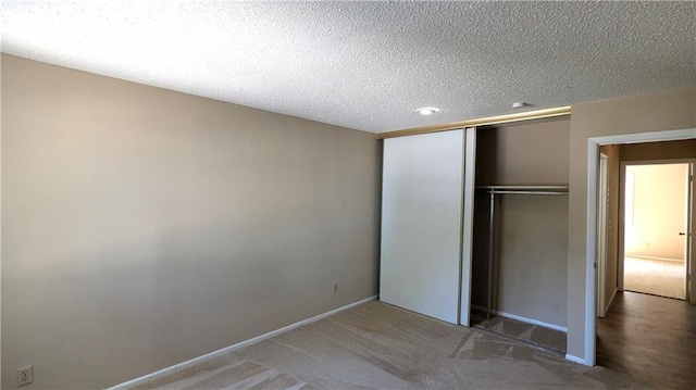 8476 Lane Dr, Raytown, MO 64138 - unfurnished bedroom featuring a closet, carpet, and a textured ceiling
