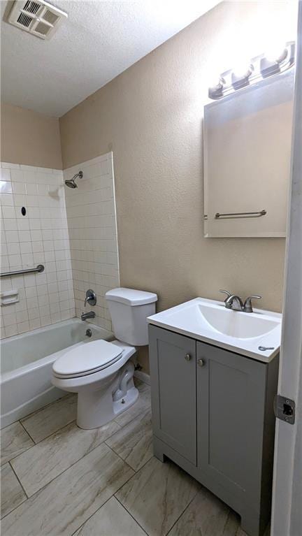 8476 Lane Dr, Raytown, MO 64138 - bathroom with vanity, shower / tub combination, a textured ceiling, and a textured wall