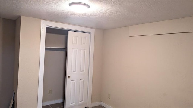 8476 Lane Dr, Raytown, MO 64138 - unfurnished bedroom with a textured ceiling and a closet