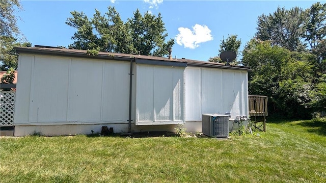 8476 Lane Dr, Raytown, MO 64138 - view of side of home featuring a lawn and a deck