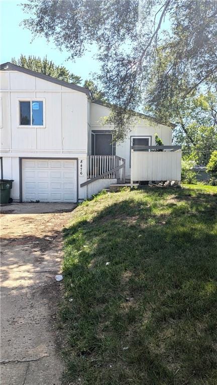 8476 Lane Dr, Raytown, MO 64138 - view of front facade with driveway and a garage