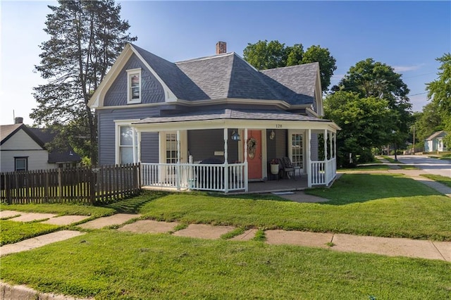 128 E Brown St, Liberty, MO 64068 - victorian home with covered porch, a shingled roof, and a chimney