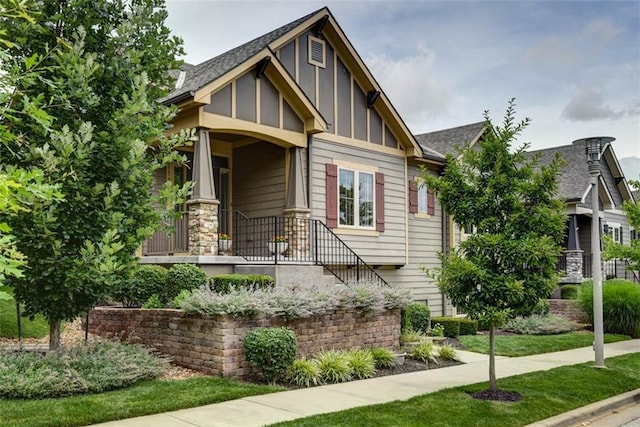 8558 Barstow St, Lenexa, KS 66219 - view of front of home with board and batten siding and roof with shingles
