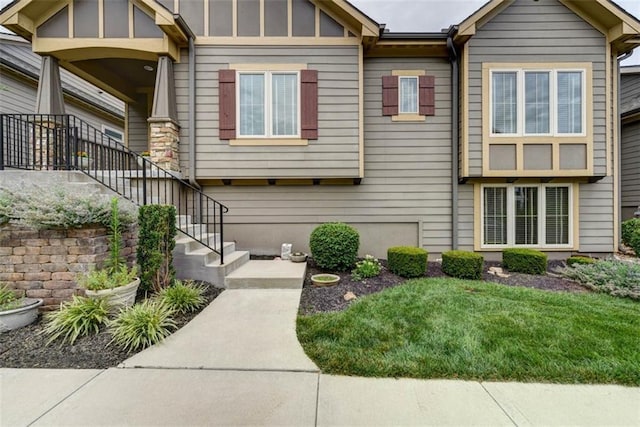8558 Barstow St, Lenexa, KS 66219 - view of front of home featuring board and batten siding, stairs, and a front yard