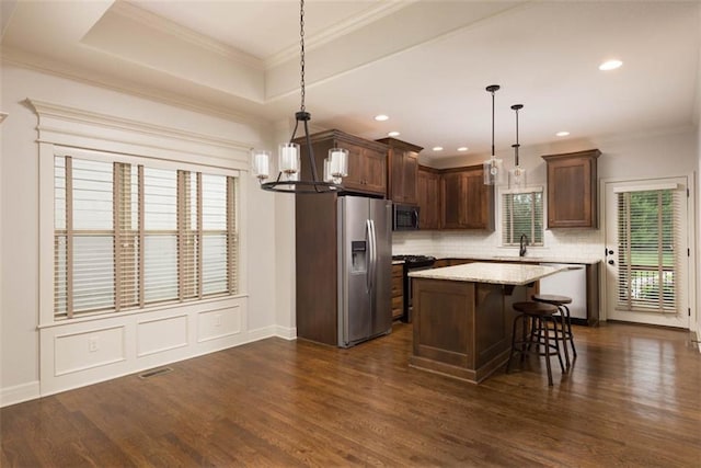 8558 Barstow St, Lenexa, KS 66219 - kitchen with appliances with stainless steel finishes, dark wood-style floors, decorative backsplash, a chandelier, and crown molding
