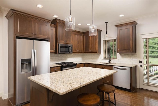 8558 Barstow St, Lenexa, KS 66219 - kitchen with stainless steel appliances, a center island, backsplash, dark wood-style flooring, and recessed lighting