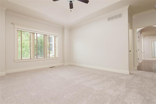 8558 Barstow St, Lenexa, KS 66219 - unfurnished room featuring arched walkways, carpet floors, ceiling fan, and ornamental molding