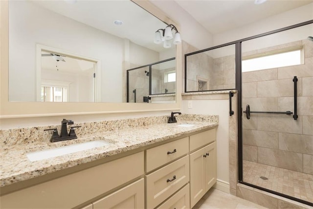 8558 Barstow St, Lenexa, KS 66219 - bathroom featuring a shower stall, double vanity, healthy amount of natural light, and tile patterned flooring