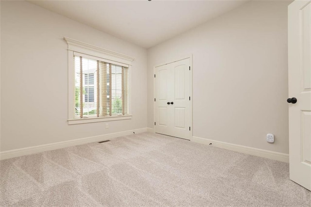 8558 Barstow St, Lenexa, KS 66219 - unfurnished bedroom with light colored carpet and baseboards
