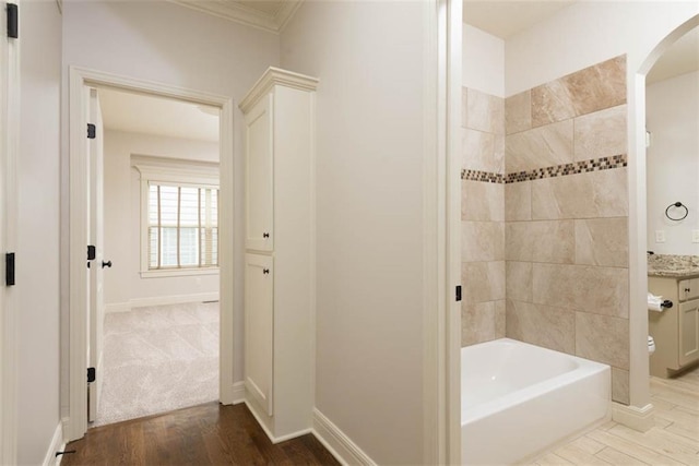 8558 Barstow St, Lenexa, KS 66219 - bathroom featuring ornamental molding, wood finished floors,  shower combination, and vanity