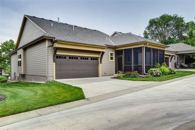 8558 Barstow St, Lenexa, KS 66219 - view of front of house featuring an attached garage, a sunroom, driveway, a front yard, and a shingled roof