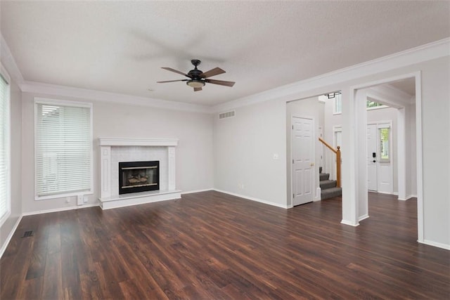 16533 W 80th St, Lenexa, KS 66219 - unfurnished living room featuring ceiling fan, stairs, crown molding, a glass covered fireplace, and wood finished floors