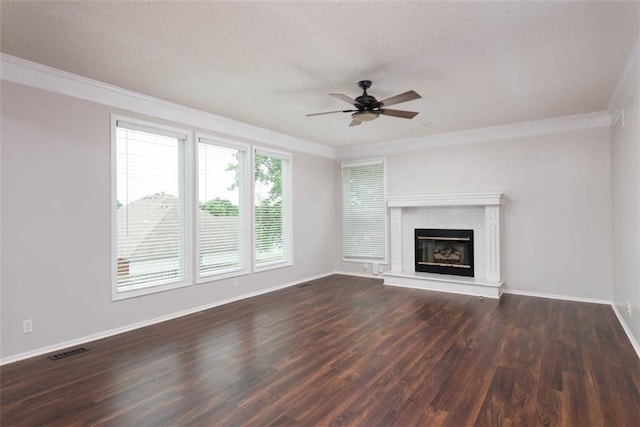 16533 W 80th St, Lenexa, KS 66219 - unfurnished living room with crown molding, a ceiling fan, dark wood-style floors, a tiled fireplace, and a textured ceiling