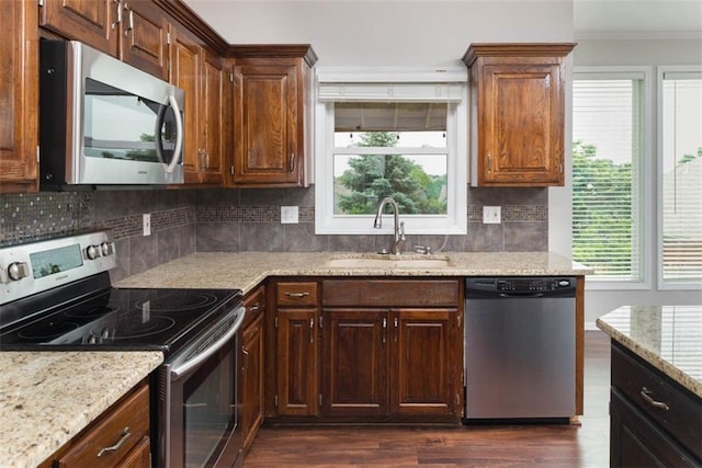 16533 W 80th St, Lenexa, KS 66219 - kitchen with appliances with stainless steel finishes, ornamental molding, dark wood-type flooring, backsplash, and light stone countertops