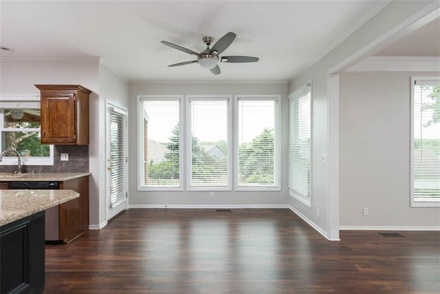 16533 W 80th St, Lenexa, KS 66219 - unfurnished dining area featuring a ceiling fan, dark wood-style flooring, and crown molding