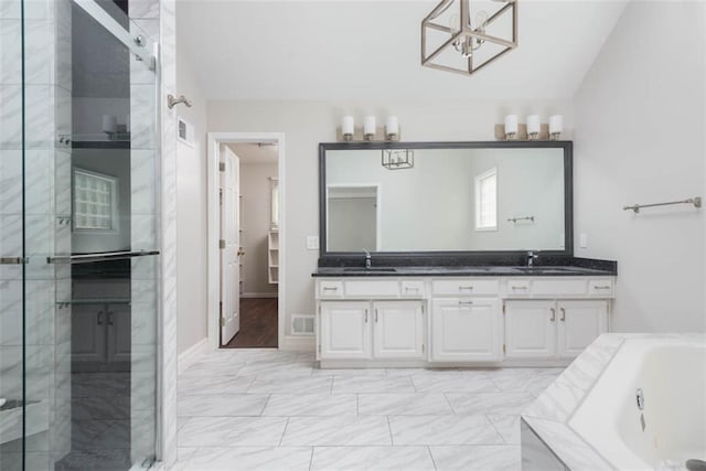 16533 W 80th St, Lenexa, KS 66219 - full bath with double vanity, a shower stall, a tub with jets, a chandelier, and marble finish floors