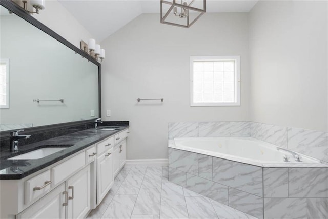 16533 W 80th St, Lenexa, KS 66219 - bathroom featuring a chandelier, a bath, marble look tile flooring, double vanity, and vaulted ceiling