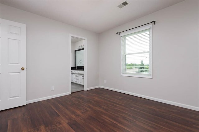 16533 W 80th St, Lenexa, KS 66219 - unfurnished bedroom featuring dark wood-style floors and connected bathroom