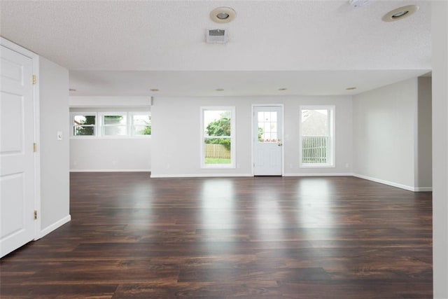 16533 W 80th St, Lenexa, KS 66219 - spare room featuring healthy amount of natural light, dark wood-style flooring, and a textured ceiling