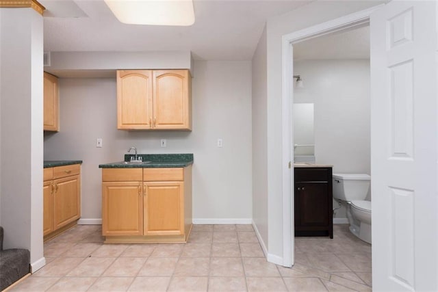 16533 W 80th St, Lenexa, KS 66219 - kitchen with light brown cabinetry, dark countertops, and light tile patterned flooring