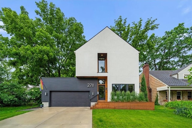 2711 W 49th St, Westwood, KS 66205 - contemporary house with a front yard, an attached garage, and driveway
